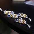 Gevederde pracht saffier broche