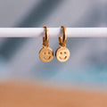 RVS oorringen met smiley – goud